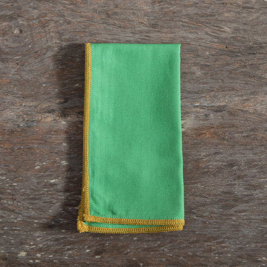 Green napkin with yellow stitch edge